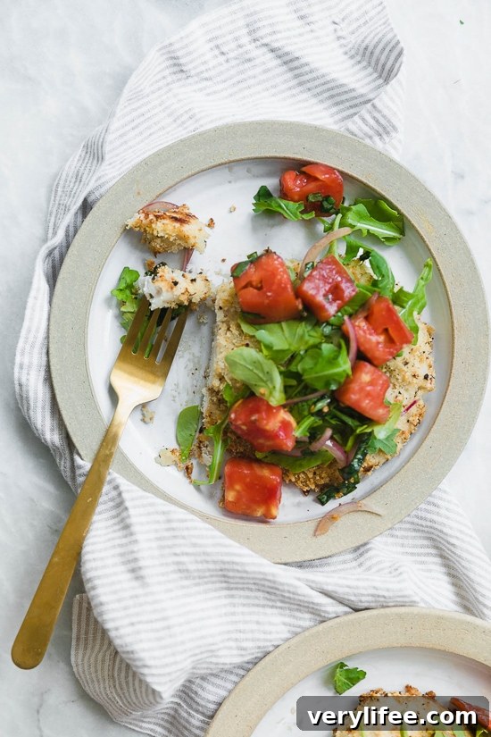 Baked Chicken Milanese is made with breaded chicken cutlets, baked in the oven topped with arugula, tomatoes and balsamic. This is my favorite restaurant dish, made healthier!