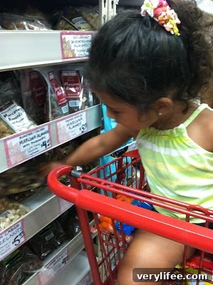 Kid-Friendly Trail Mix Recipe and Fun School Lunch Ideas 3 Child picking ingredients for trail mix