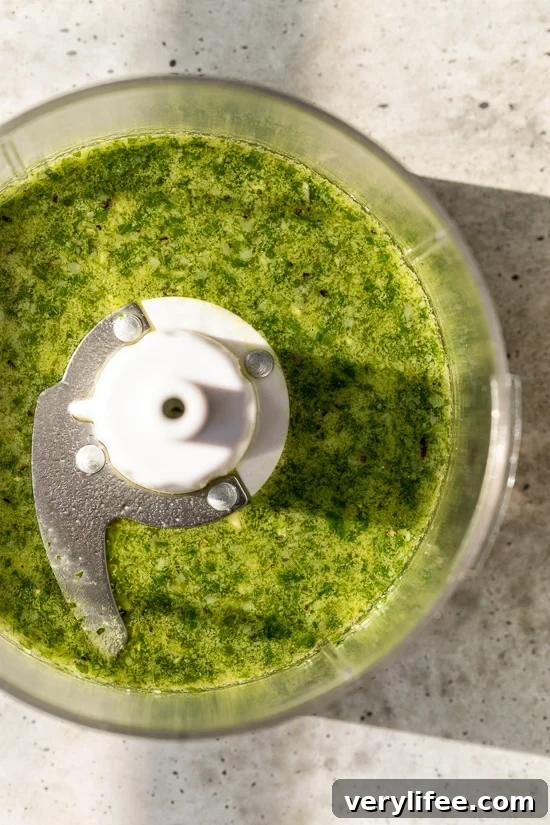 Homemade basil pesto in food processor bowl