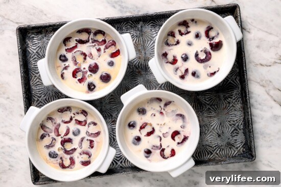 3 cherry clafoutis on pan before baking.