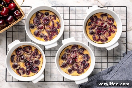 4 cherry clafoutis on wire cooling rack.