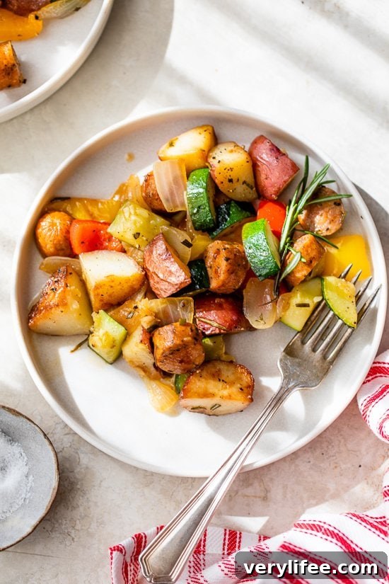 One-Pan Sausage, Potatoes and Summer Vegetables 3 Sausage, bell peppers, zucchini and potatoes in a skillet