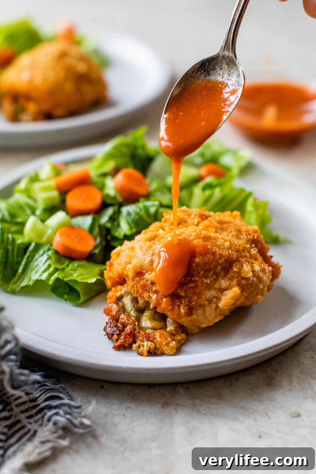 Buffalo Chicken Stuffed Breasts with Creamy Cheese Filling 7 drizzling hot sauce over stuffed chicken breast