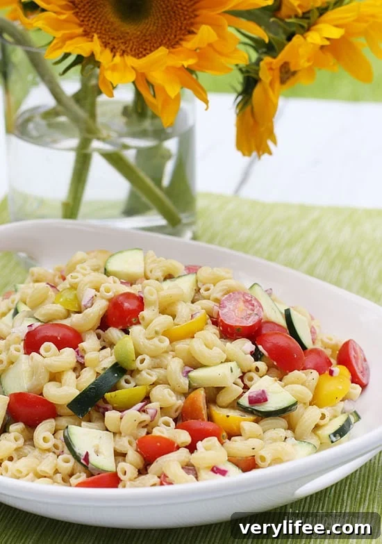 Refreshing Summer Macaroni Salad with Tomatoes and Zucchini 2 Macaroni Salad with Tomatoes and Zucchini is the perfect summer pasta salad loaded with fresh summer vegetables tossed in a light creamy dressing.