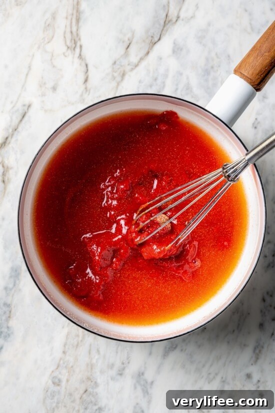 How to Make Homemade Ketchup from Scratch 5 Overhead view of ingredients for homemade ketchup in saucepan with whisk