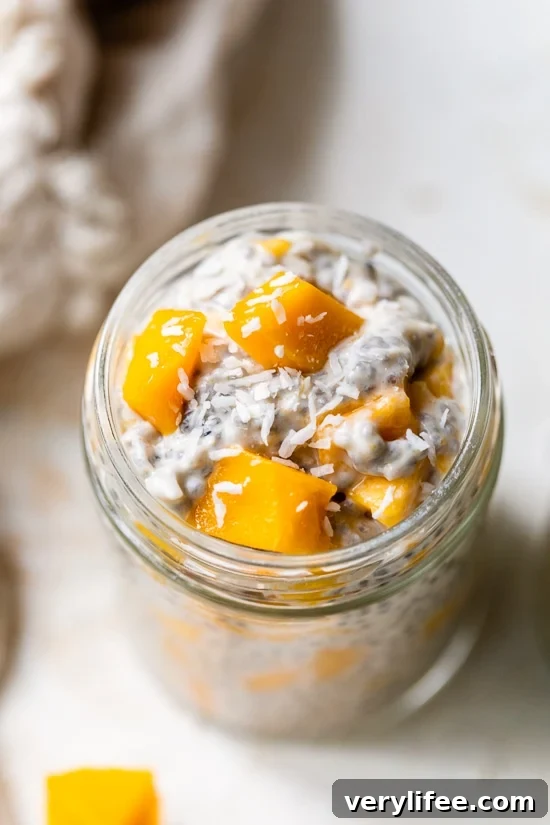 A mason jar filled with coconut chia pudding topped with mango.