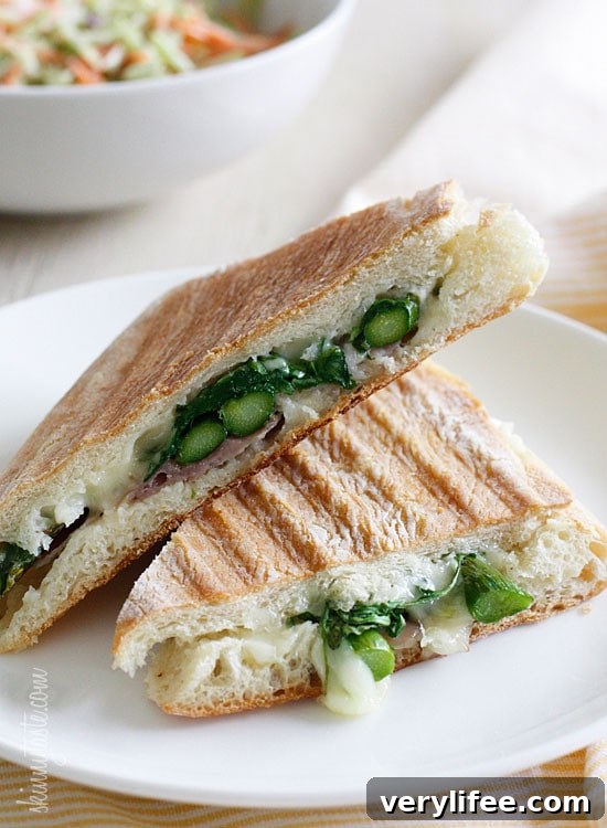 Grilled Asparagus and Prosciutto Panini with Garlic Mayo 3 Melted Swiss cheese, asparagus, prosciutto, arugula and garlic mayonnaise pressed in a ciabatta panini.