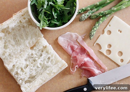 Grilled Asparagus and Prosciutto Panini with Garlic Mayo 4 Melted Swiss cheese, asparagus, prosciutto, arugula and garlic mayonnaise pressed in a ciabatta panini.