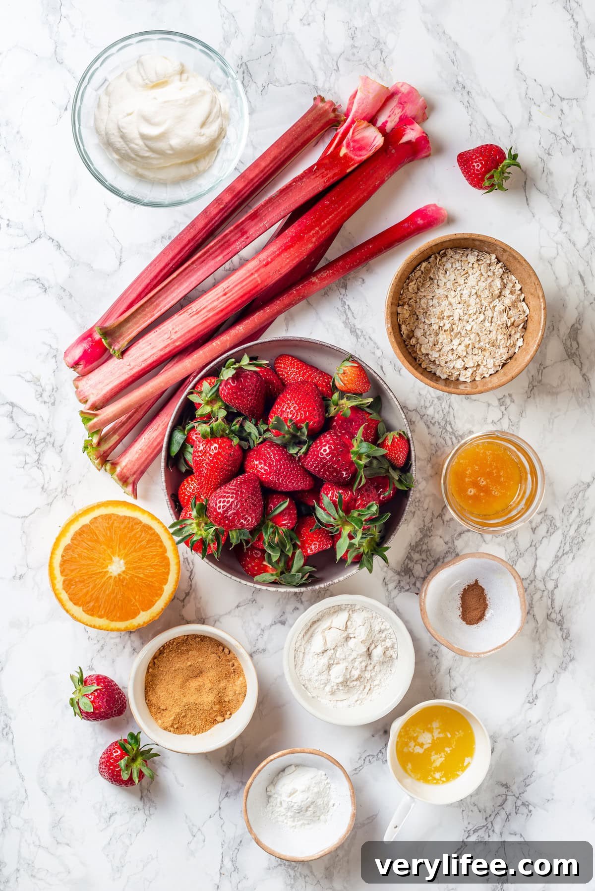 Honey adds the perfect amount of sweetness to the filling in this strawberry rhubarb crisp recipe. Easy to make and impossible to resist! Overhead view of ingredients for strawberry rhubarb crisp