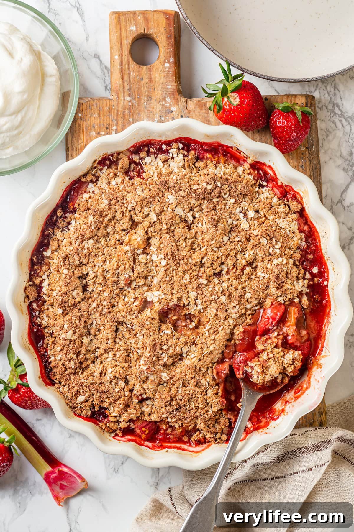 Fresh from the oven Overhead view of strawberry rhubarb crisp in baking dish with spoon