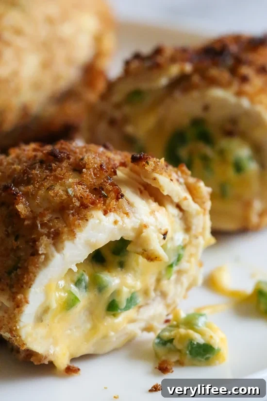 Crispy Baked Chicken Stuffed with Cheesy Jalapeno Poppers 4 What happens when you combine Baked Jalapeño Poppers with chicken?? Oh yeah baby!! Cheesy stuffed chicken breast stuffed with diced jalapeño, cream cheese, cheddar jack cheese, scallions and bacon!