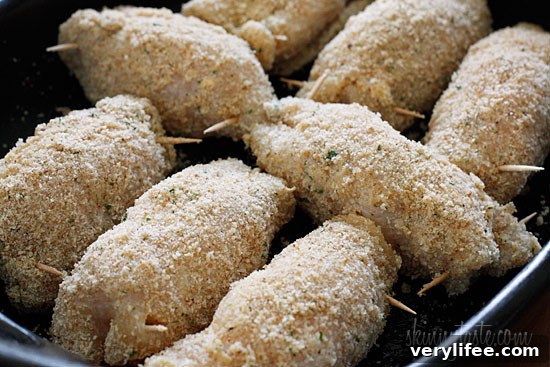 Crispy Baked Chicken Stuffed with Cheesy Jalapeno Poppers 9 Chicken rolled with filling, prodded with toothpick and breaded.