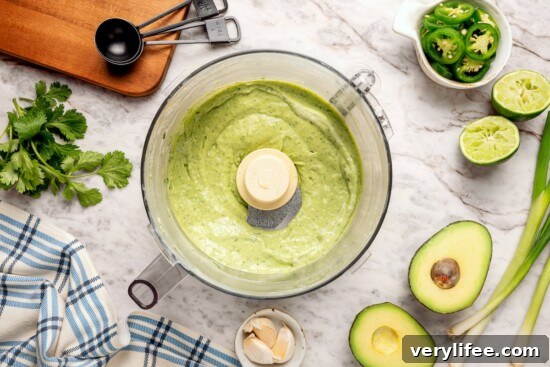 Creamy Avocado, Cilantro and Lime Dressing 6 Zesty avocado cilantro lime dressing in food processor bowl.
