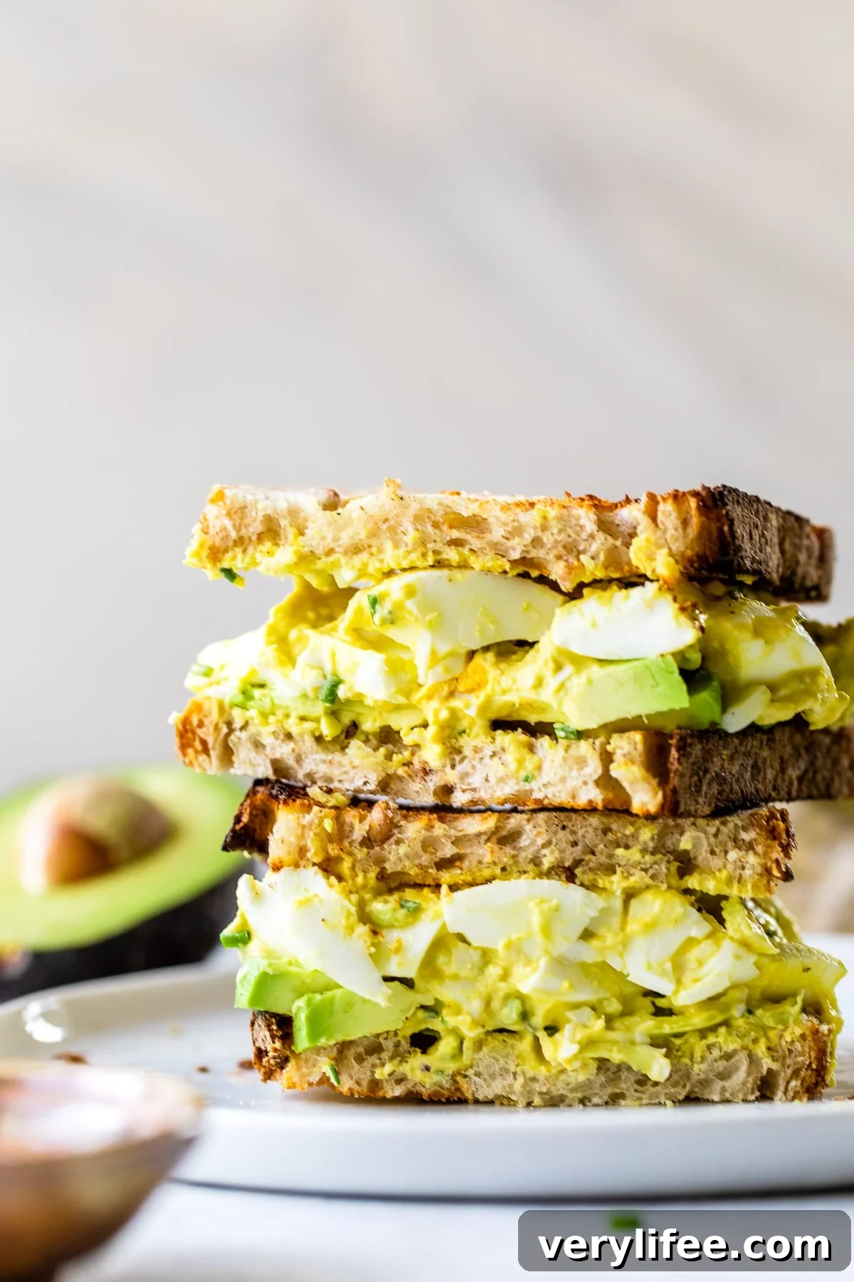 Avocado Egg Salad sandwich cut in half.