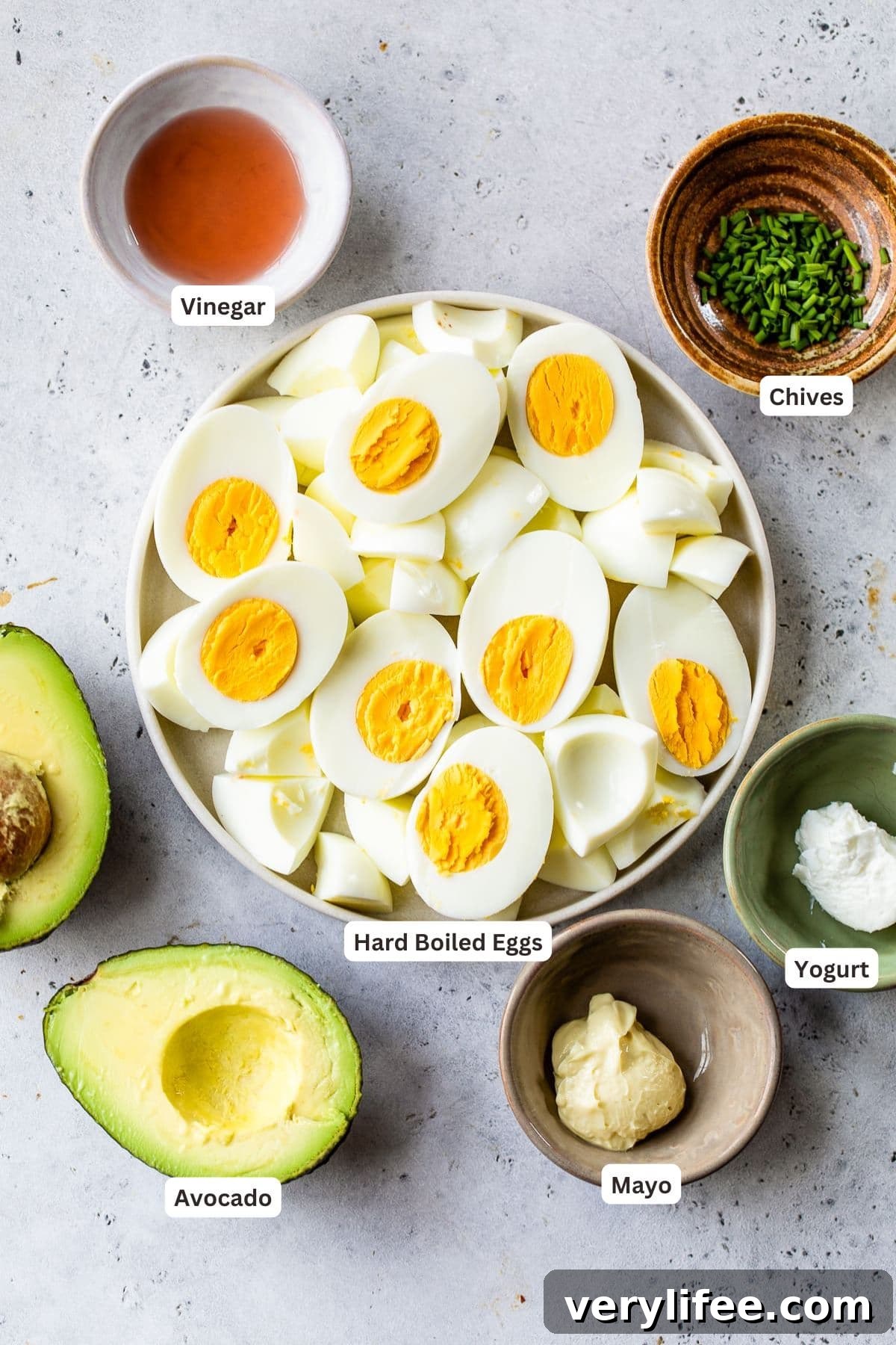 Ingredients for avocado egg salad in a bowl.