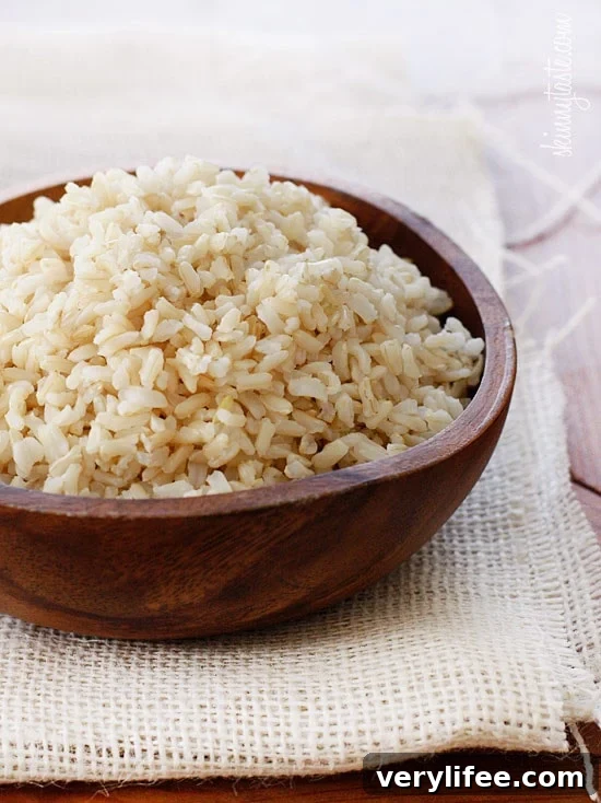 Want to know how to cook perfect brown rice? This easy, foolproof brown rice recipe will give you perfect rice that is never sticky. A bowl filled with cooked brown rice.
