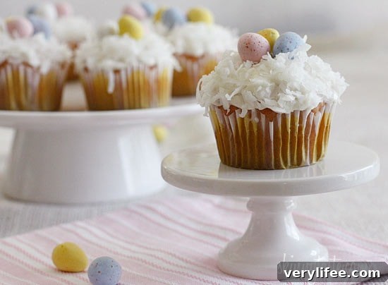Quick and easy coconut cupcake with light cream cheese frosting and sweetened coconut flakes