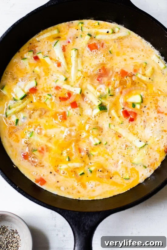 Caramelized Onion, Red Pepper and Zucchini Skillet Frittata 5 Eggs poured into a skillet