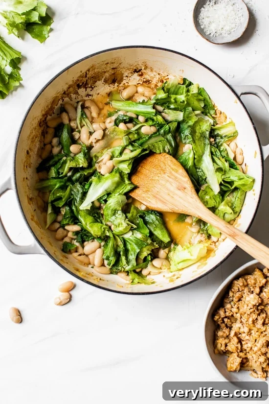 Adding beans and escarole to a pot.