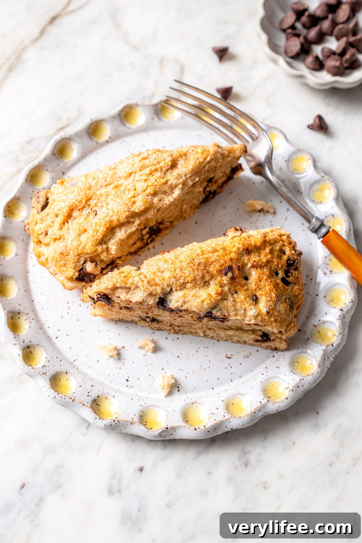Chocolate Chip Scones Recipe: Tender, Buttery, Flaky 12 Two chocolate chip scones on plate with fork