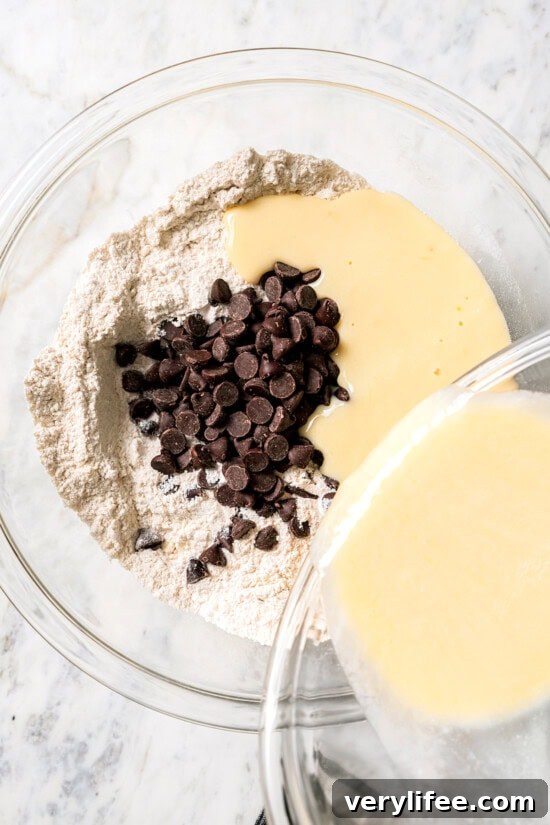 Chocolate Chip Scones Recipe: Tender, Buttery, Flaky 5 Pouring liquid into dry ingredients for scones