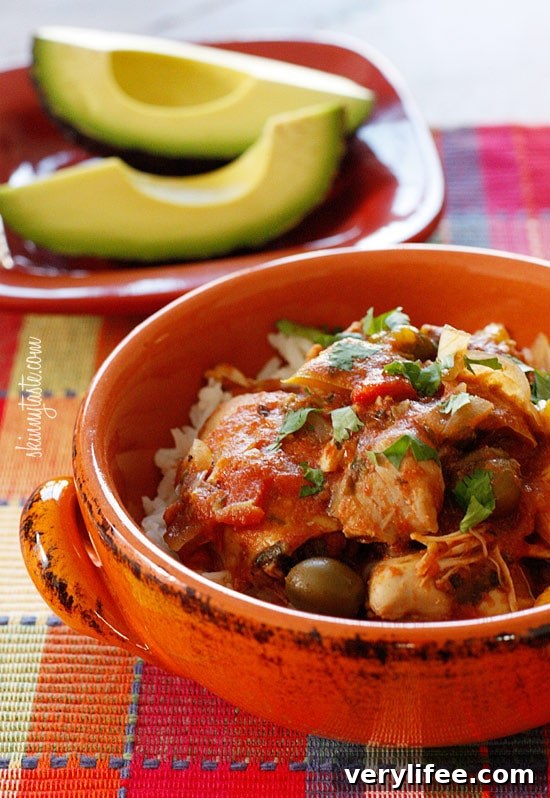 Chicken a la Criolla, a simple yet flavorful Latin dish made with stewed boneless skinless chicken thighs bell peppers, onions, garlic, tomatoes, olives, cilantro and spices.