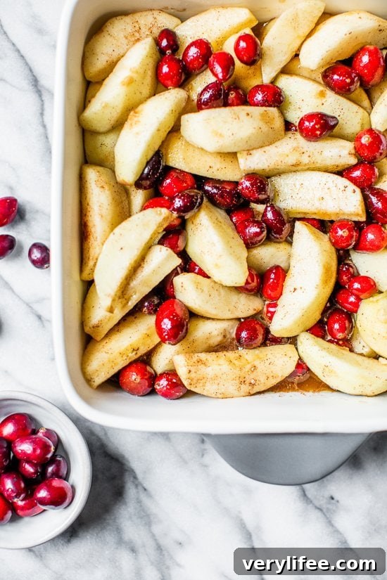 apples and cranberries in a baking dish.