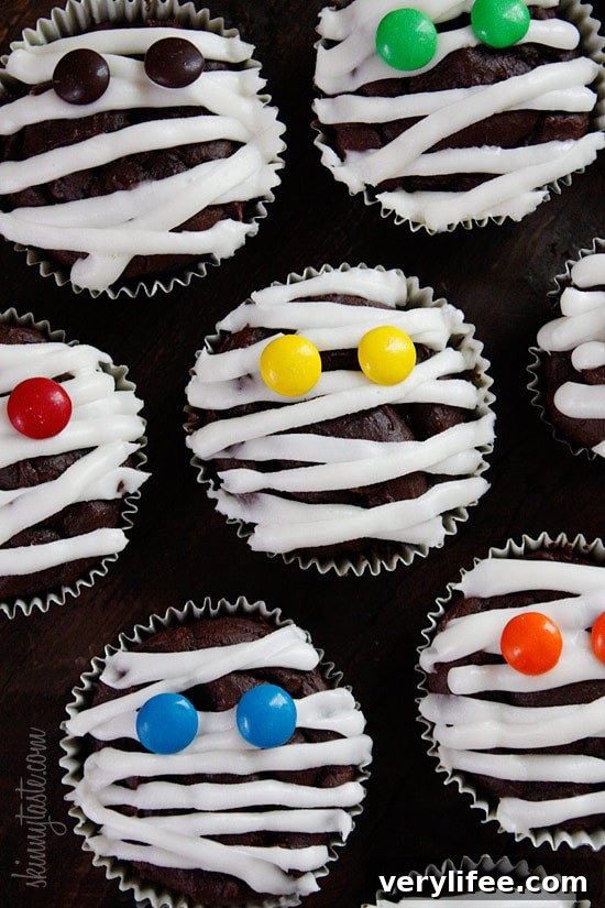 These are healthy Chocolate Mummy cupcakes with vanilla frosting, wouldn't these be so cute to bring to a Halloween party!