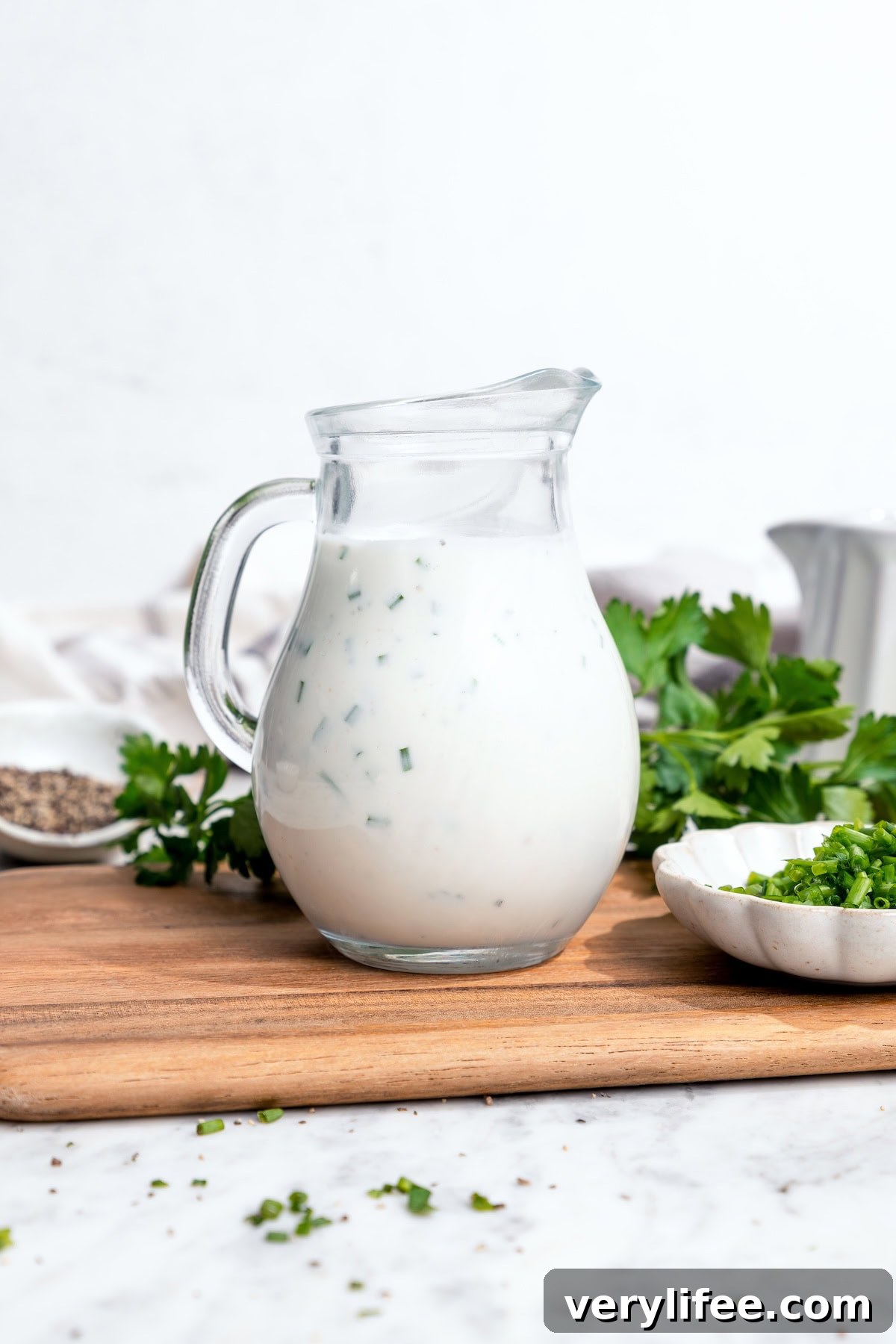 This lightened-up buttermilk ranch dressing is creamy, tangy, and full of fresh herbs. Pitcher of buttermilk ranch dressing.