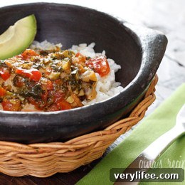 Authentic Sofrito Chicken Stew Recipe 6 Sofrito Chicken Stew plated over rice with cilantro and avocado.