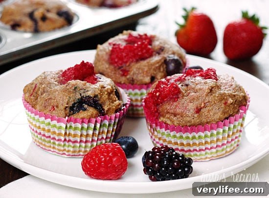 Whole Wheat Mixed Berry Muffins Recipe 3 Mixed berry whole wheat muffins cooling on a rack.