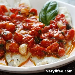 Plated broiled fish with grape tomato sauce