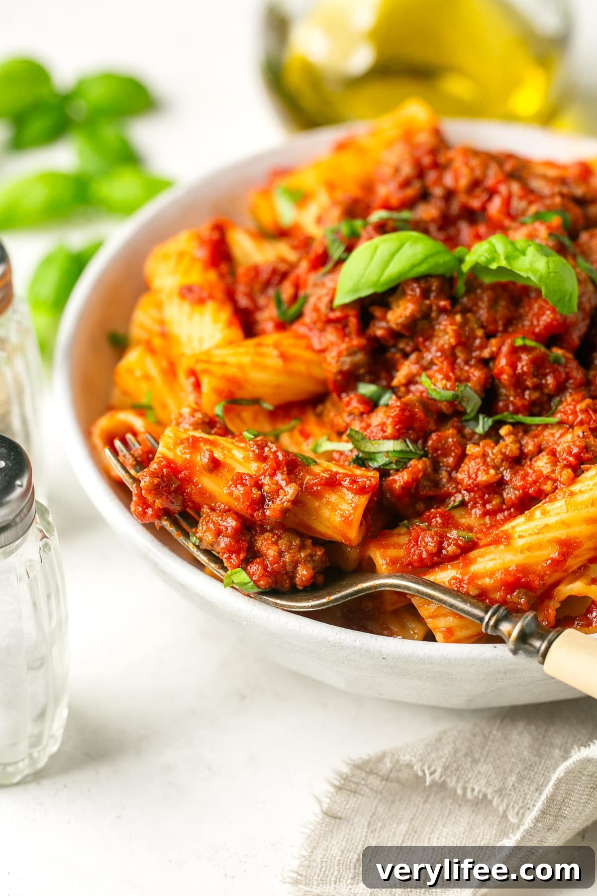 Crock Pot Sausage Pasta Sauce Recipe 2 A bowl with sausage pasta sauce served over rigatoni.