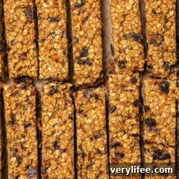 Sliced chewy granola bars on parchment paper.