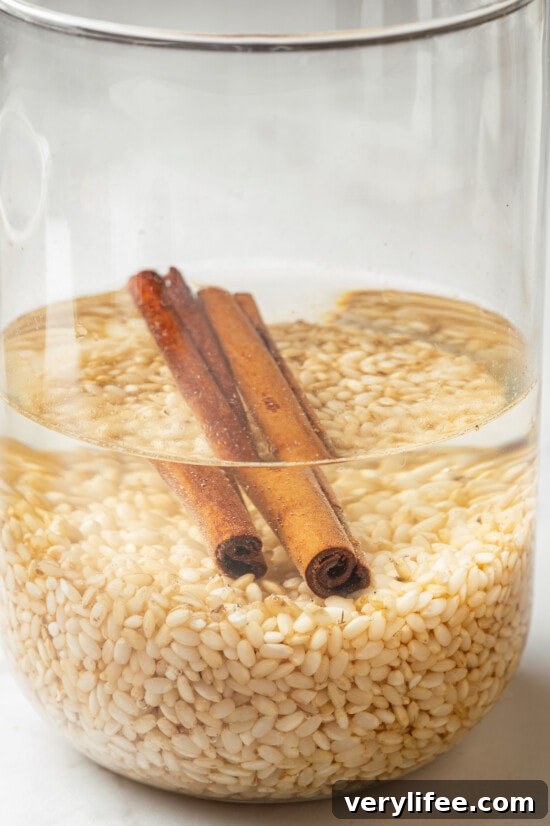 Brown rice and cinnamon sticks soaking in water
