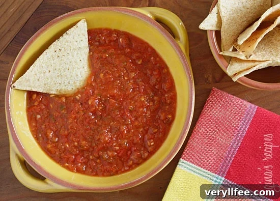 This spicy red salsa is made with fresh tomatoes, roasted jalapeño, garlic and cilantro, pureed in a blender then simmered until the tomatoes deepen in color. Serve with your favorite baked chips and a cold margarita!