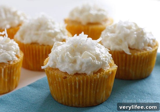 Pineapple and coconut top these light pineapple cupcakes, what a perfect Spring dessert! For the coconut lover out there, these are super easy, low fat, moist and delicious!