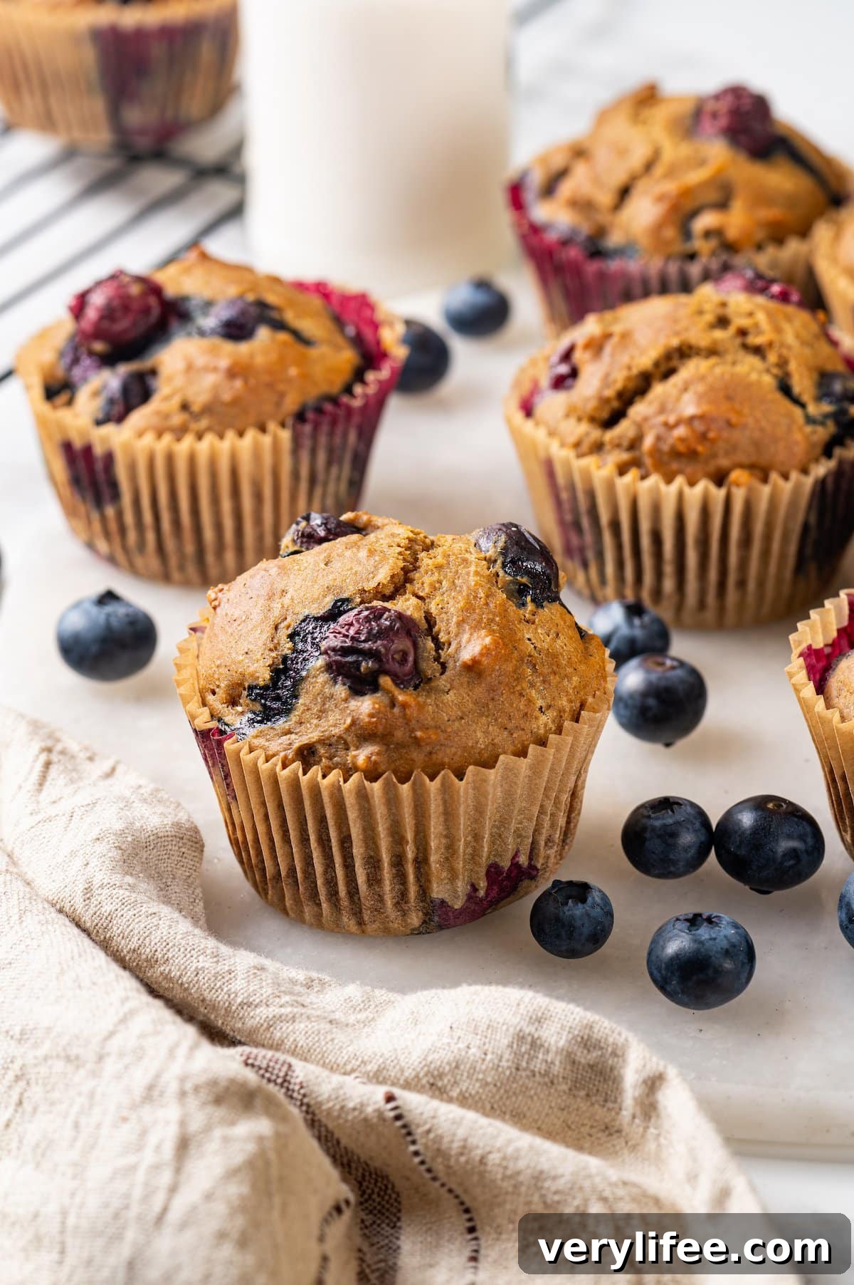 Fresh whole wheat blueberry muffins Blueberry muffins on marble board with fresh berries