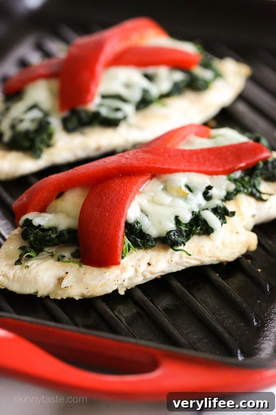 Grilled Chicken with Spinach and Melted Mozzarella Recipe 2 Grilled chicken topped with sauteed garlicky spinach, mozzarella and roasted peppers