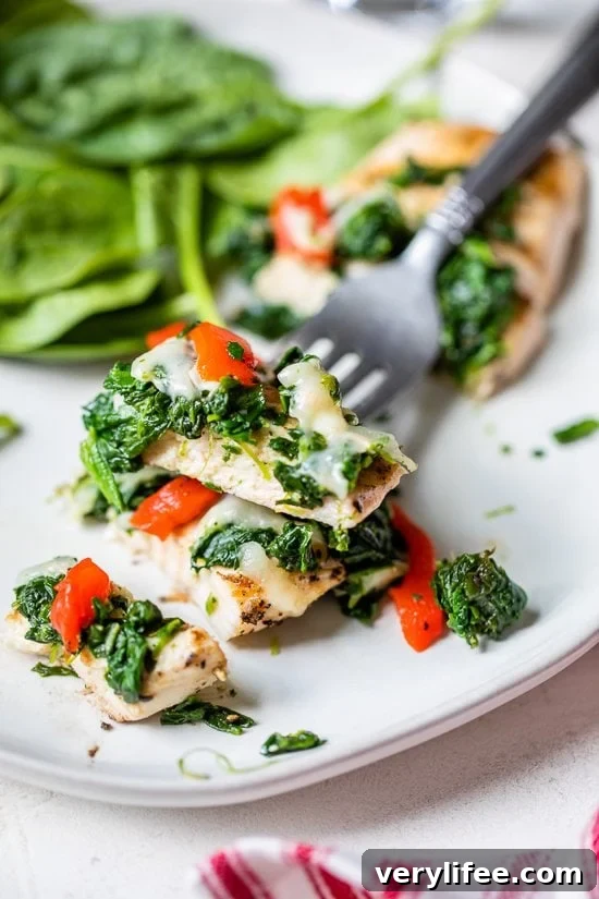 Grilled Chicken with Spinach and Melted Mozzarella Recipe 3 Grilled Chicken with Spinach and Melted Mozzarella on a fork