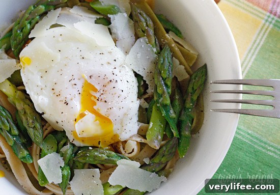 Asparagus poached eggs over pasta tri-color