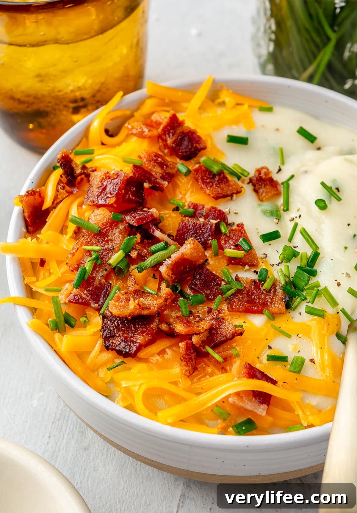 Bowl of loaded baked potato soup with toppings