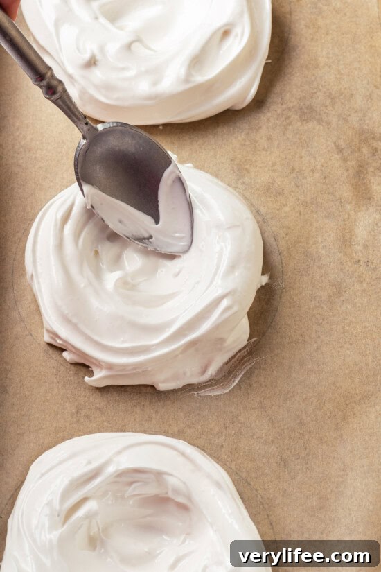 Form meringue nests Using spoon to form meringue nest for pavlova