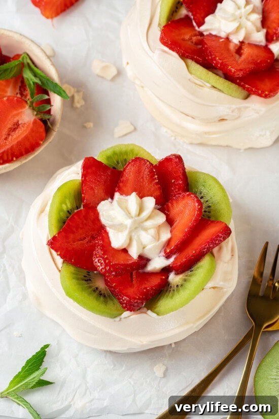 Top with fresh fruit Top-down view of pavlova with strawberries and kiwi