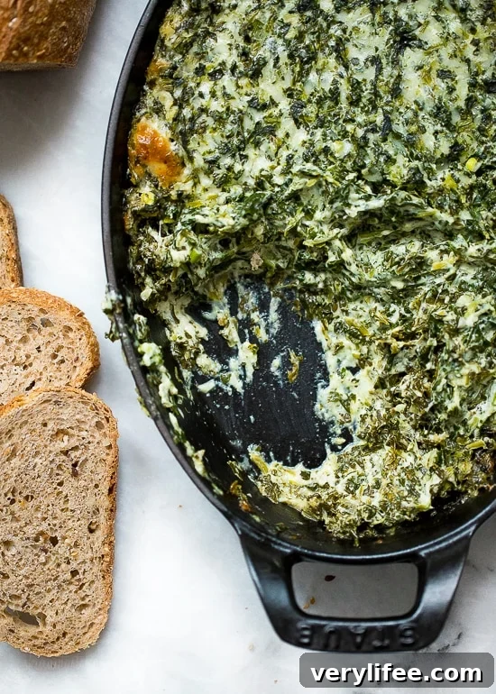 Cheesy hot spinach dip in baking dish