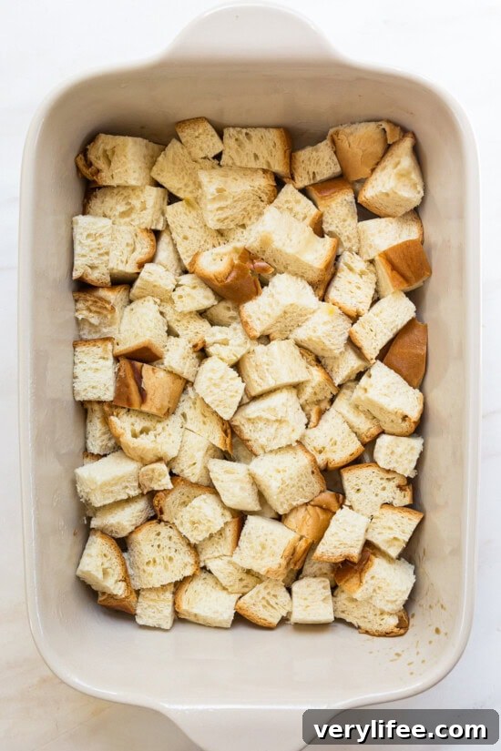 Cubes of challah bread in a casserole dish.
