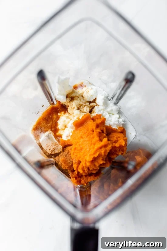 Pumpkin smoothie ingredients in a blender