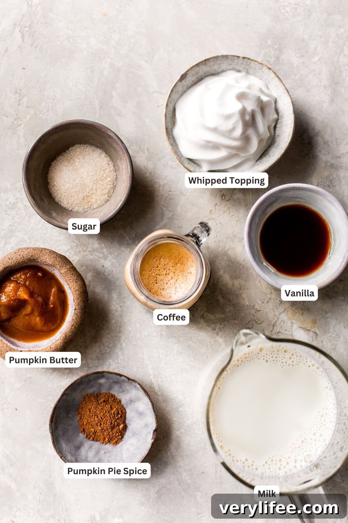 Homemade Pumpkin Spice Latte Recipe 5 Pumpkin spice latte ingredients on a marble counter.