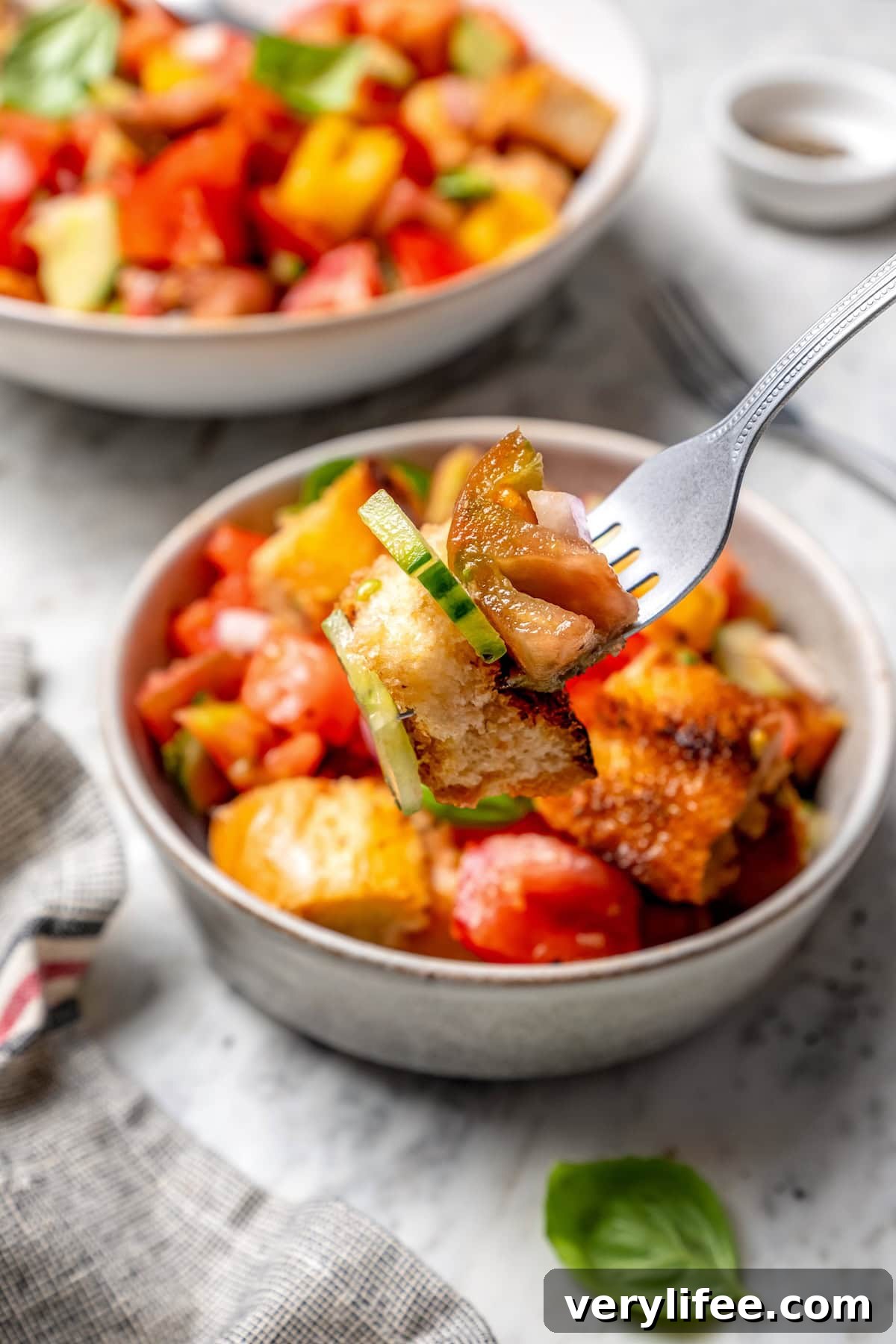 Forkful of panzanella held over bowl