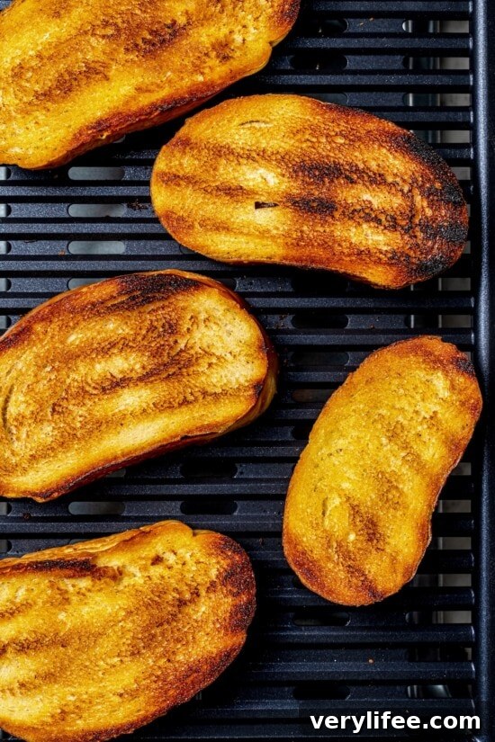 Overhead view of bread slices toasting on indoor grill